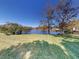 Landscaped backyard with a pond view and lush green grass at 104 Woodingham Dr, Venice, FL 34292