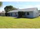 Large backyard with lush lawn and partial home view at 104 Woodingham Dr, Venice, FL 34292