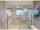 Elegant bathroom with a large walk-in shower and marble walls at 104 Woodingham Dr, Venice, FL 34292