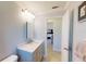 Modern bathroom with gray vanity, marble countertop, and tiled shower at 104 Woodingham Dr, Venice, FL 34292