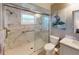 Bathroom boasts a walk-in shower, marble finishes, and modern fixtures at 104 Woodingham Dr, Venice, FL 34292
