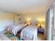 Guest bedroom with two twin beds and water view at 104 Woodingham Dr, Venice, FL 34292