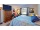 Spacious bedroom with a large bed, TV, and ample closet space at 104 Woodingham Dr, Venice, FL 34292