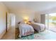 Guest bedroom with two twin beds and backyard access at 104 Woodingham Dr, Venice, FL 34292