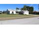 Single-story house with a white garage door and palm trees at 104 Woodingham Dr, Venice, FL 34292