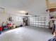 Spacious garage with storage shelving and room for two cars at 104 Woodingham Dr, Venice, FL 34292
