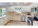 Modern kitchen with granite countertops and stainless steel appliances at 104 Woodingham Dr, Venice, FL 34292