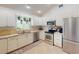Modern kitchen featuring stainless steel appliances and white cabinets at 104 Woodingham Dr, Venice, FL 34292
