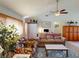 Living room featuring comfortable seating and home office setup at 104 Woodingham Dr, Venice, FL 34292
