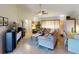 Living room with a cozy seating area and workspace near window at 104 Woodingham Dr, Venice, FL 34292