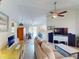 Living room with beige couch and view into dining area at 104 Woodingham Dr, Venice, FL 34292