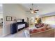 Living room showcasing comfortable seating and large TV at 104 Woodingham Dr, Venice, FL 34292