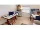 Spacious home office featuring two desks and a comfortable sitting area at 104 Woodingham Dr, Venice, FL 34292
