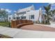 Modern curved wood bench near brick pathway and building at 10792 Tarflower Dr # 202, Venice, FL 34293