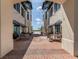 Brick paved courtyard with tables and chairs under awnings at 10792 Tarflower Dr # 202, Venice, FL 34293