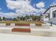 Landscaped green space with benches and modern buildings in the background at 10792 Tarflower Dr # 202, Venice, FL 34293