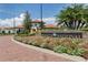 Community entrance with landscaped grounds and signage at 10792 Tarflower Dr # 202, Venice, FL 34293
