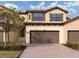 Two story home with brown garage door and landscaping at 10792 Tarflower Dr # 202, Venice, FL 34293