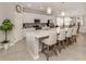 Modern kitchen with white cabinets, island, and stainless steel appliances at 10792 Tarflower Dr # 202, Venice, FL 34293