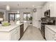 Modern kitchen with white cabinets and a large island at 10792 Tarflower Dr # 202, Venice, FL 34293