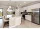 Modern kitchen with white cabinets, quartz countertops, and stainless steel appliances at 10792 Tarflower Dr # 202, Venice, FL 34293