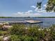 Floating dock on a lake with lush greenery at 10792 Tarflower Dr # 202, Venice, FL 34293