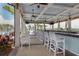 Outdoor bar with seating and views of the pool at 10792 Tarflower Dr # 202, Venice, FL 34293