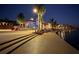 Evening view of waterfront walkway and clubhouse at 10792 Tarflower Dr # 202, Venice, FL 34293