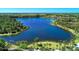 Peaceful lakefront view with walking path at 11409 Okaloosa Dr, Venice, FL 34293
