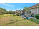 Landscaped backyard with large lawn and view of neighboring homes at 11409 Okaloosa Dr, Venice, FL 34293