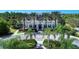 Community clubhouse with lush landscaping and palm trees at 11409 Okaloosa Dr, Venice, FL 34293