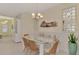 Bright dining room with glass-top table, built-in bench, and coastal decor at 11409 Okaloosa Dr, Venice, FL 34293