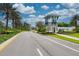 Gated community entrance with palm trees and landscaping at 11409 Okaloosa Dr, Venice, FL 34293