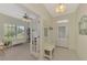 Bright entryway with built-in bench, office view, and French doors at 11409 Okaloosa Dr, Venice, FL 34293