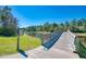 Wooden footbridge over tranquil lake in a resort community at 11409 Okaloosa Dr, Venice, FL 34293