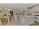 Spacious kitchen with white cabinets, island, and breakfast bar at 11409 Okaloosa Dr, Venice, FL 34293