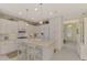 Kitchen with white cabinets, large island, and stainless steel appliances at 11409 Okaloosa Dr, Venice, FL 34293