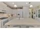 Island kitchen with white cabinets, granite countertops, and breakfast bar at 11409 Okaloosa Dr, Venice, FL 34293