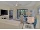 Spacious living room with comfortable seating, access to lanai, and large TV at 11409 Okaloosa Dr, Venice, FL 34293