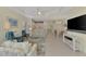 Open living room with view of kitchen, dining, and sliding glass doors at 11409 Okaloosa Dr, Venice, FL 34293