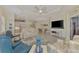 Bright living room features comfortable seating, a large TV, and an open floor plan at 11409 Okaloosa Dr, Venice, FL 34293