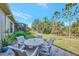 Private patio with seating area and view of lush landscaping at 11409 Okaloosa Dr, Venice, FL 34293