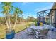 Relaxing patio with seating area and view of trees and lawn at 11409 Okaloosa Dr, Venice, FL 34293