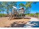 Wooden playground structure with climbing areas and slide at 11409 Okaloosa Dr, Venice, FL 34293