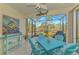 Bright screened lanai with a table, chairs, and a view of the backyard at 11409 Okaloosa Dr, Venice, FL 34293