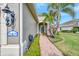 Brick walkway leading to the house entrance with landscaping at 11409 Okaloosa Dr, Venice, FL 34293