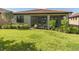 Large backyard with grassy area and view of home's back at 11945 Lovegrass St, Venice, FL 34293