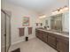 Primary bathroom with double vanity, granite countertop, and large shower at 11945 Lovegrass St, Venice, FL 34293