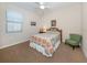 Guest bedroom with full-size bed and an accent chair at 11945 Lovegrass St, Venice, FL 34293