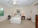 Relaxing bedroom with a queen-size bed, soft lighting, and a seating area at 11945 Lovegrass St, Venice, FL 34293